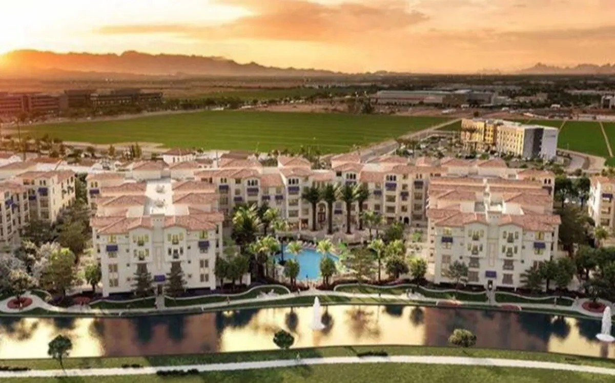 This image features the property’s impressive exterior amenities, including a sparkling swimming pool surrounded by manicured lawns, palm trees, and a decorative fountain. The apartment buildings rise in the background, and the inviting pool area hints at a vibrant community atmosphere perfect for relaxing after a round of golf.